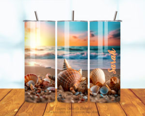 All sides of tumbler showing seashells on beach with ocean waves